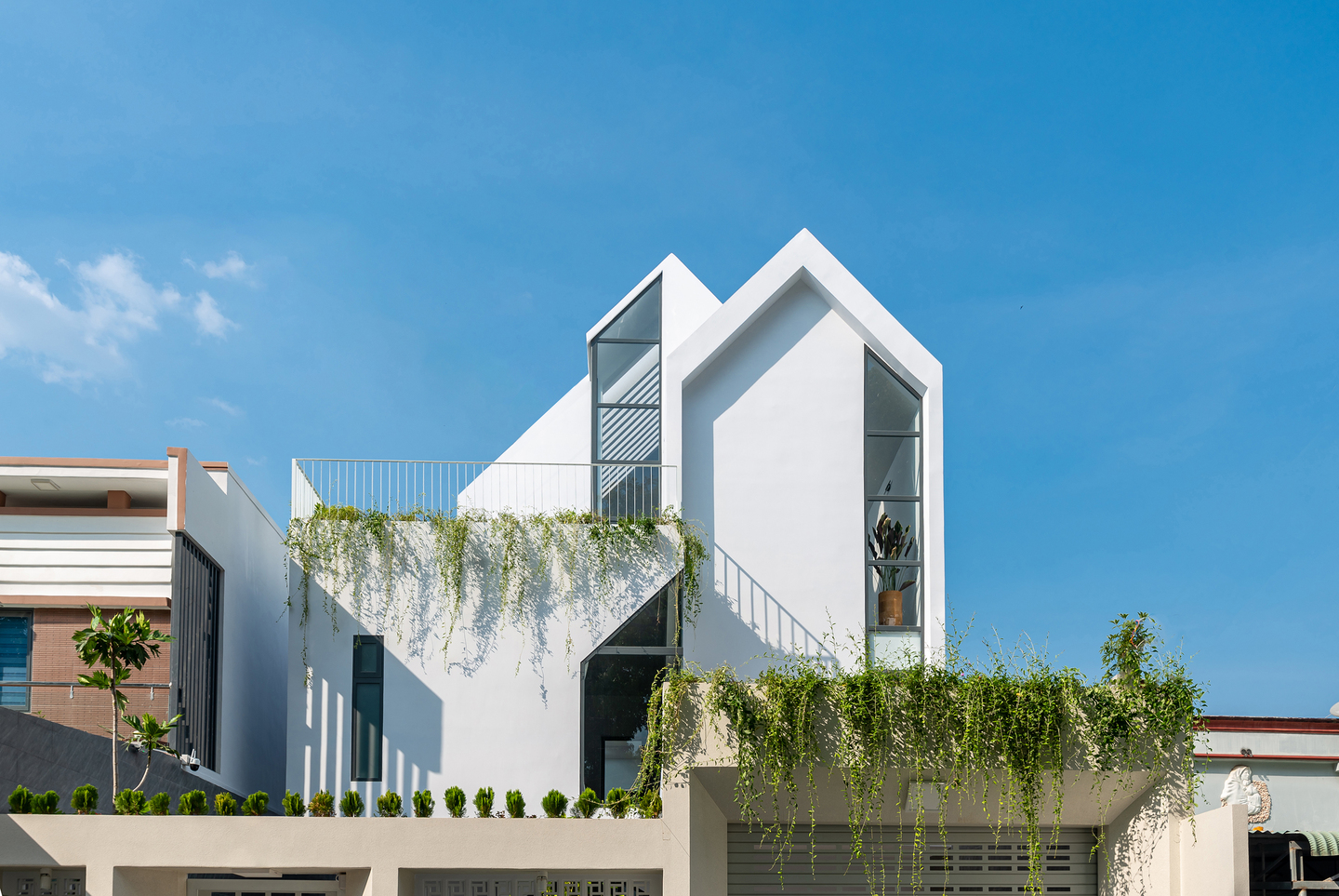 Gather House 以純白外牆，結合三角形屋頂和幾何造型窗戶，展現出極簡又輕快的當代住宅樣貌。